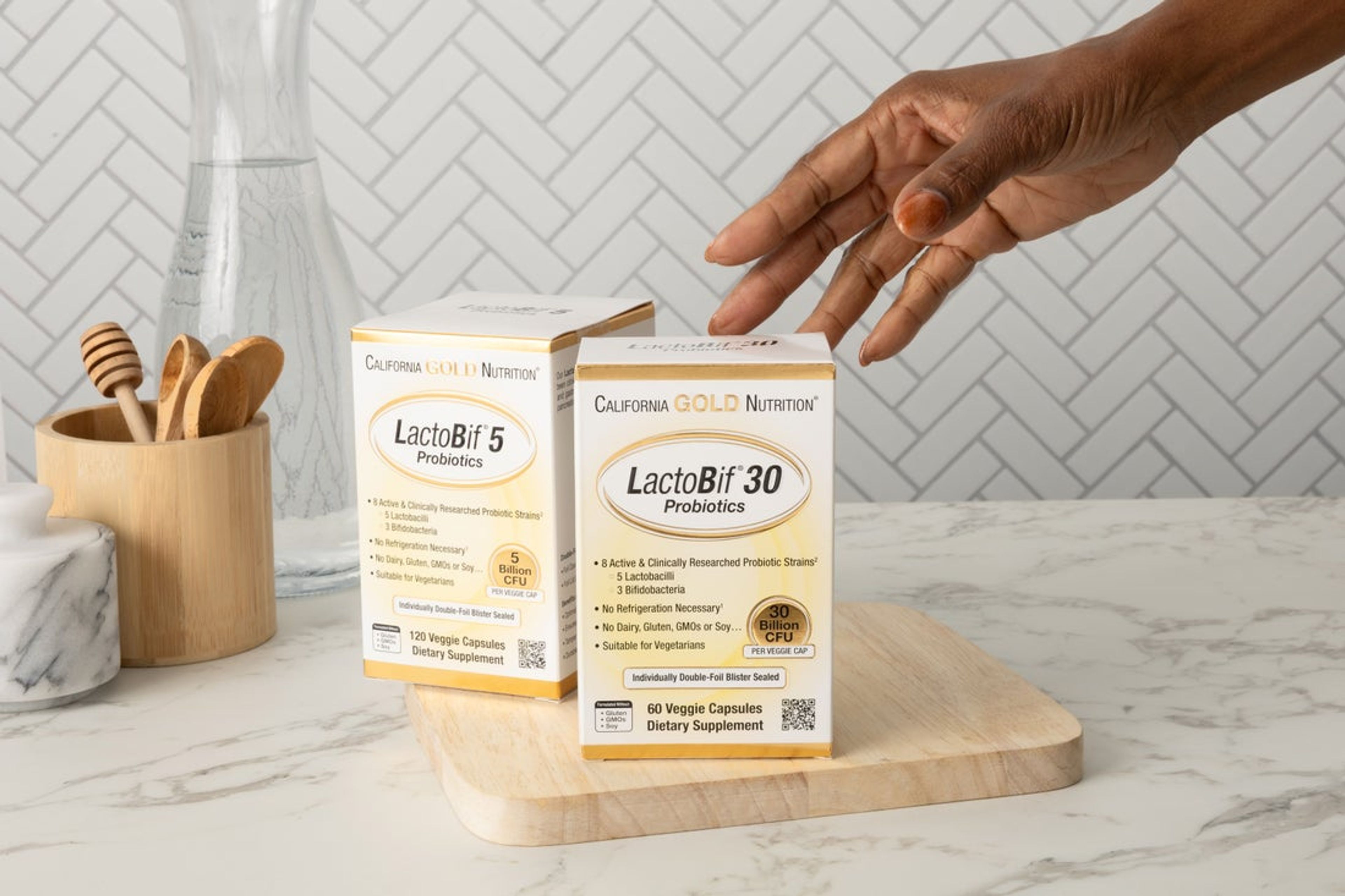 Image of hand touching the capsules 
