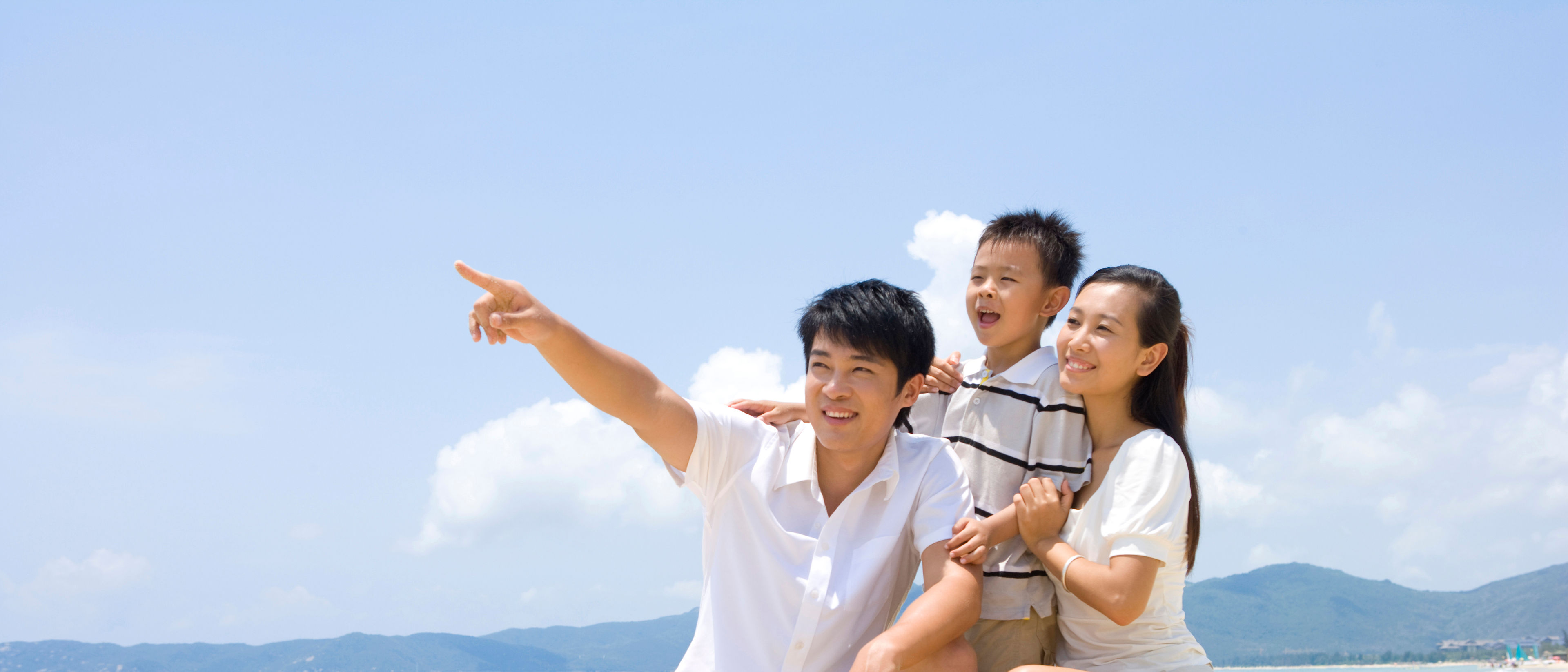 Young family playing on the beach