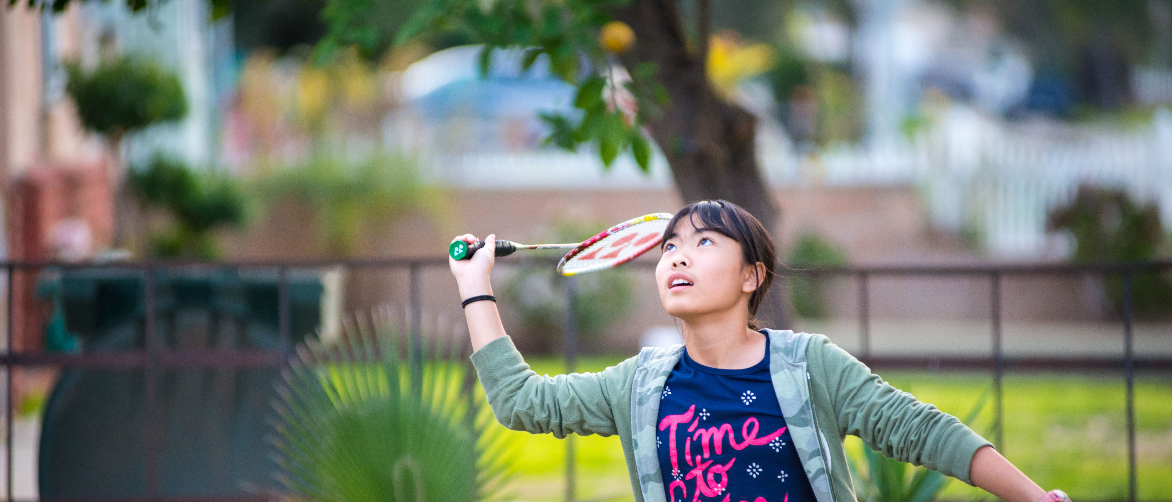 Young girl playing badminton